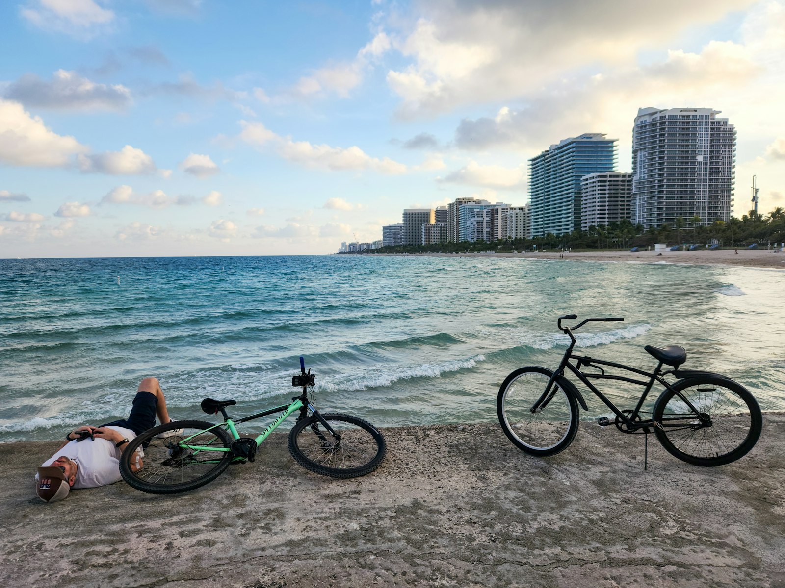 Bicycles on a seawall with the Miami Beach skyline behind