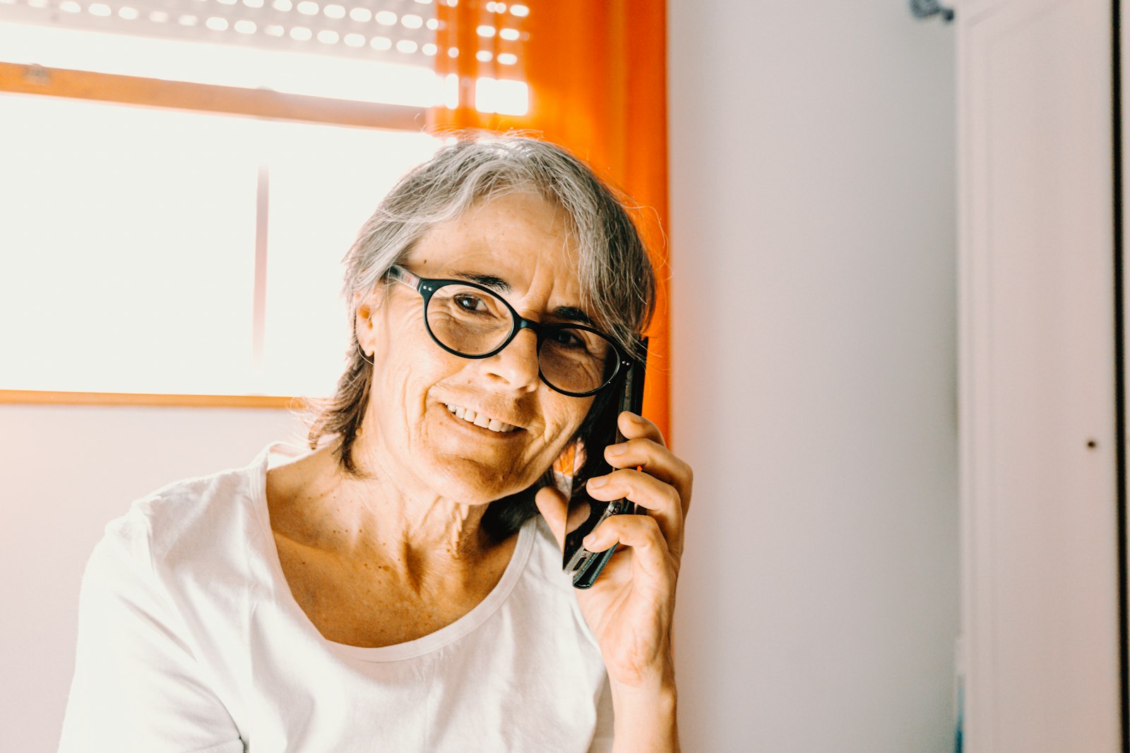 Smiling older woman talking on the phone