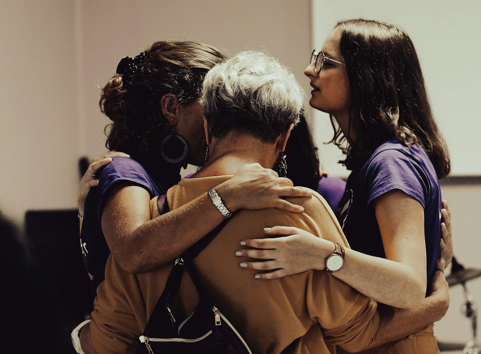 Three women sharing a group hug