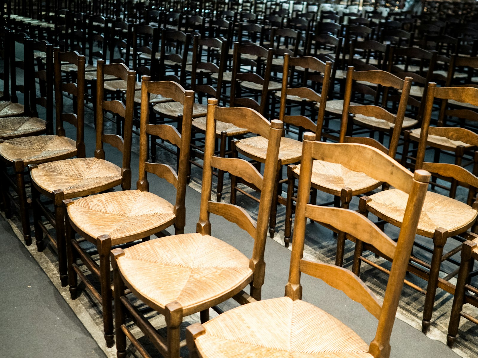 Rows of empty wooden chairs
