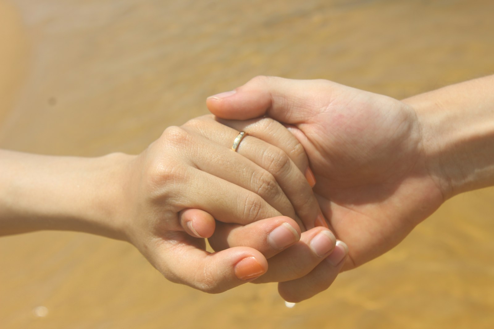 Two hands clasped in support