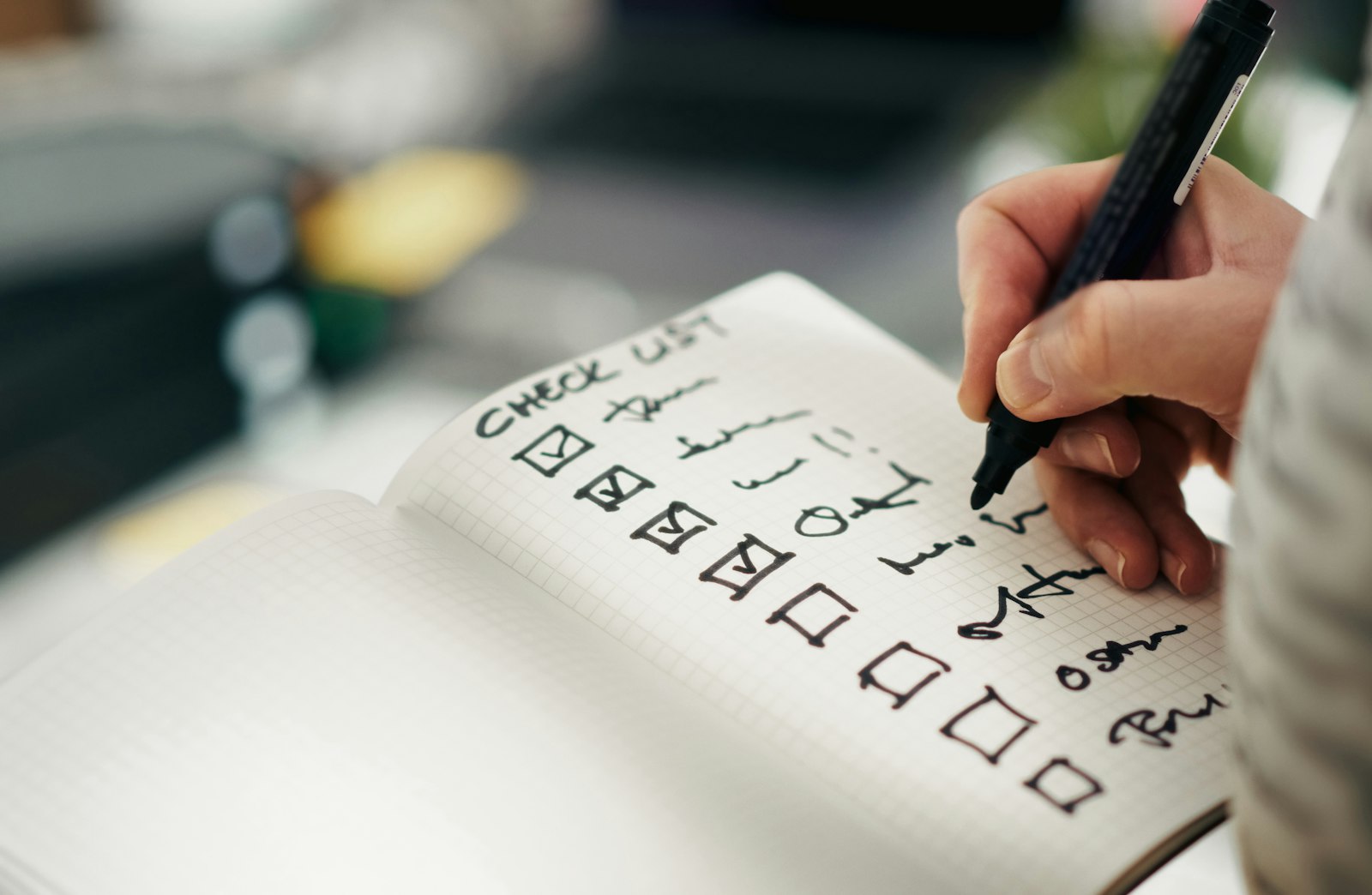 A hand ticking items on a checklist