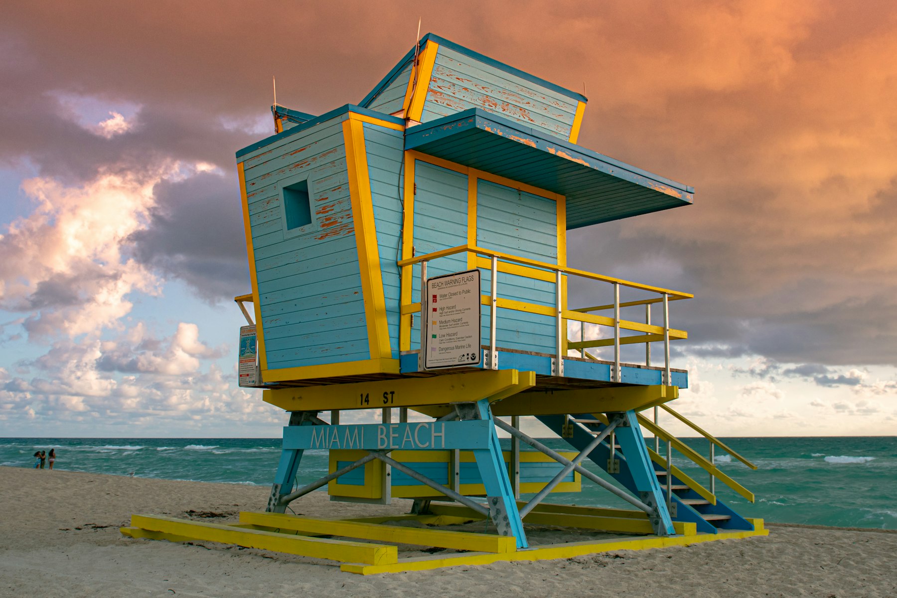 A pastel lifeguard tower on the beach at sunrise
